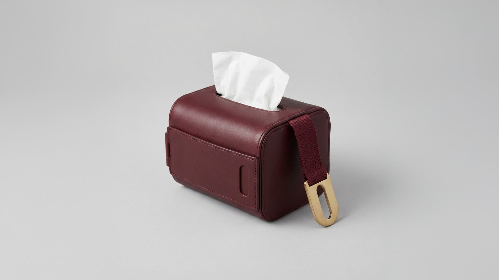 Cove, a burgundy leather tissue holder with a brass purse clip
